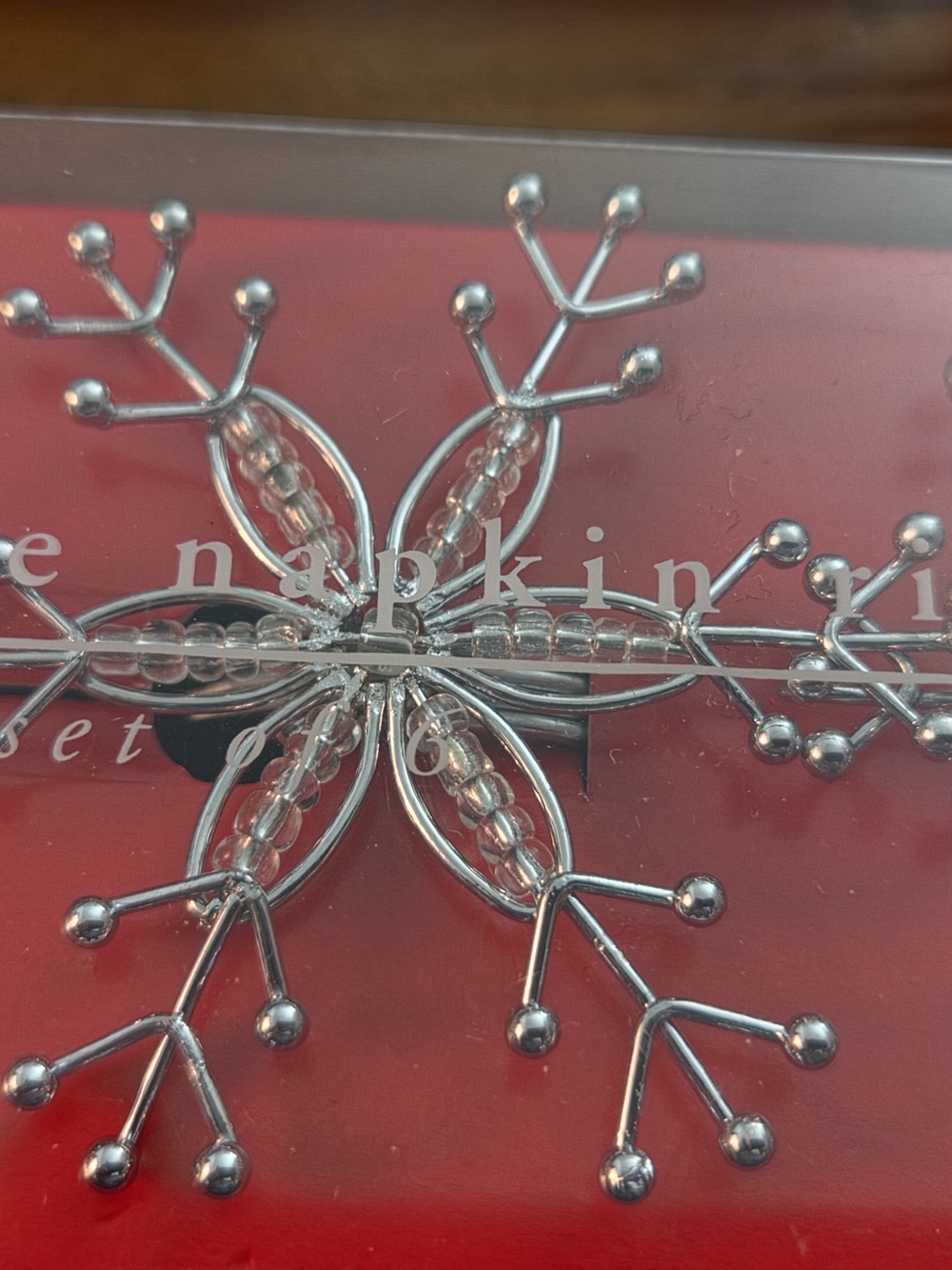 Pier 1 Silver Snowflake Napkin Ring on Red